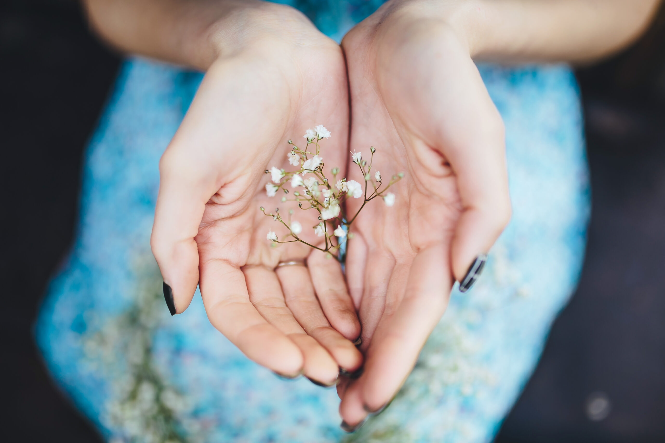 beautiful girl walks in the lush garden dressed in a wreath